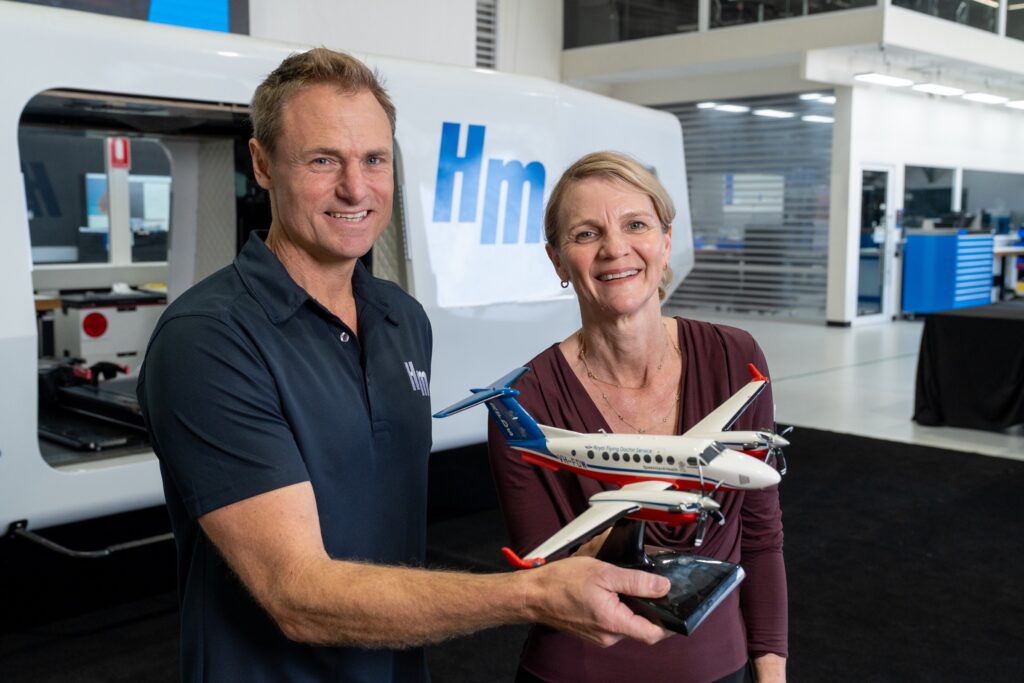 HeliMods Founder Will Shrapnel and an RFDS (Queensland Section) representative holding a model of the Beechcraft King Air 260C in RFDS livery